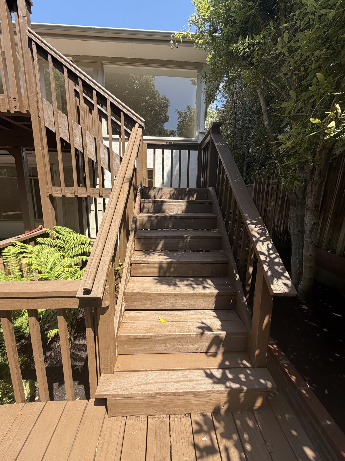 Rebuilt wooden deck stairs with railing